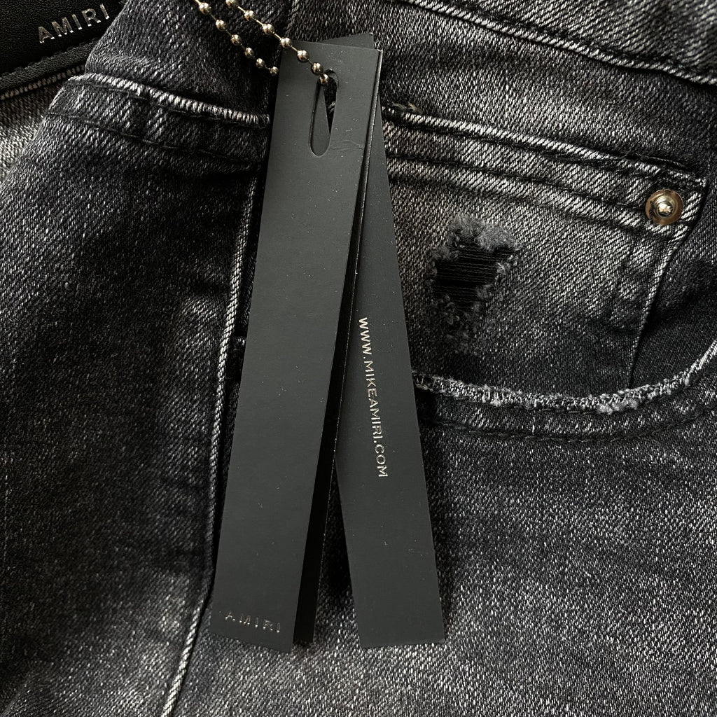 AMIRI VARSITY LOGO REPAIR JEANS