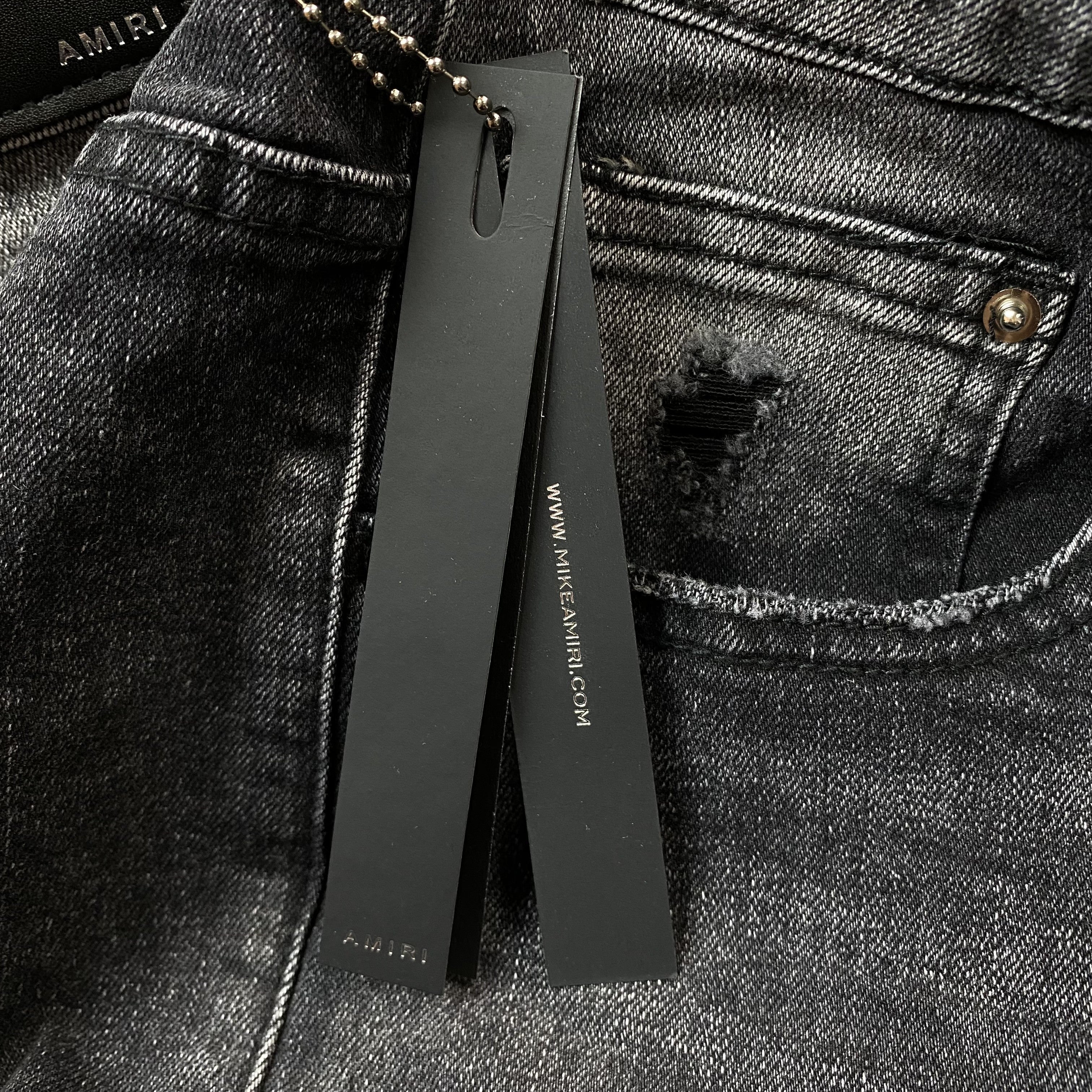 AMIRI VARSITY LOGO REPAIR JEANS