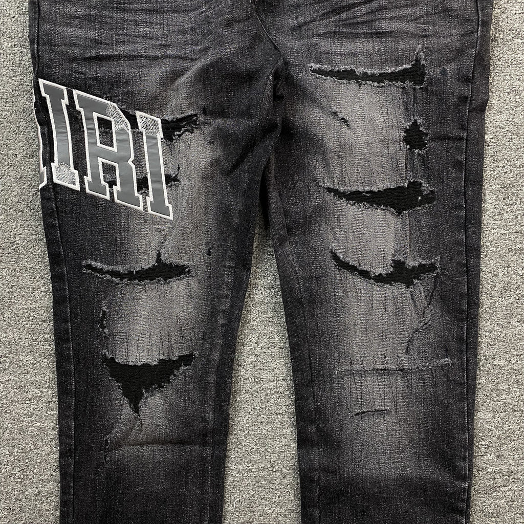 AMIRI VARSITY LOGO REPAIR JEANS